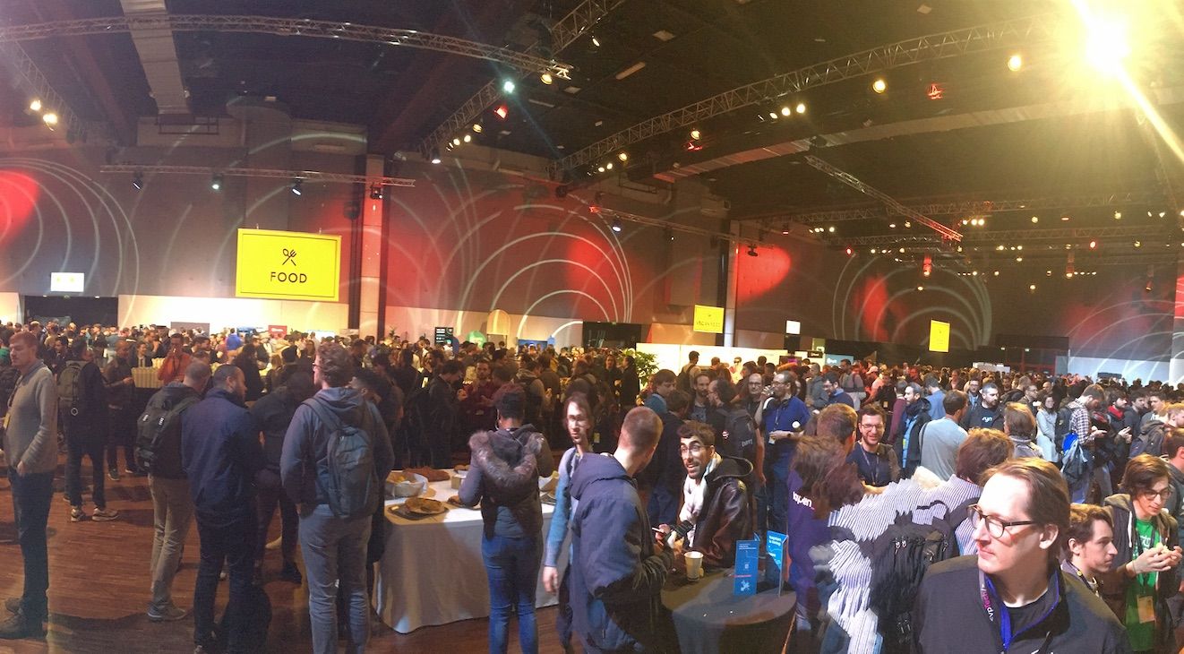 dotJS 2019 conference attendees during break, expo hall at capacity.